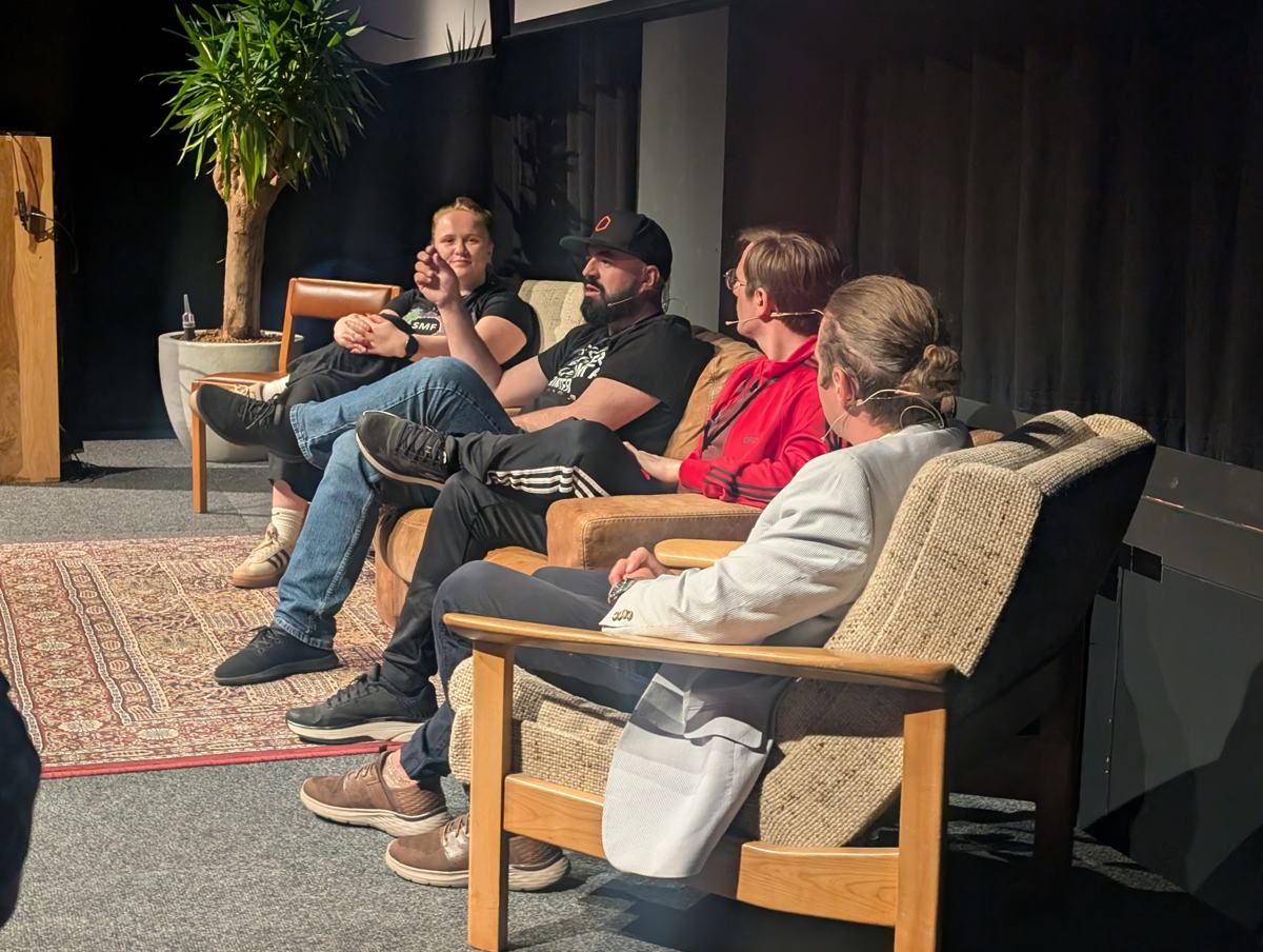 Creators talking on sofas on stage